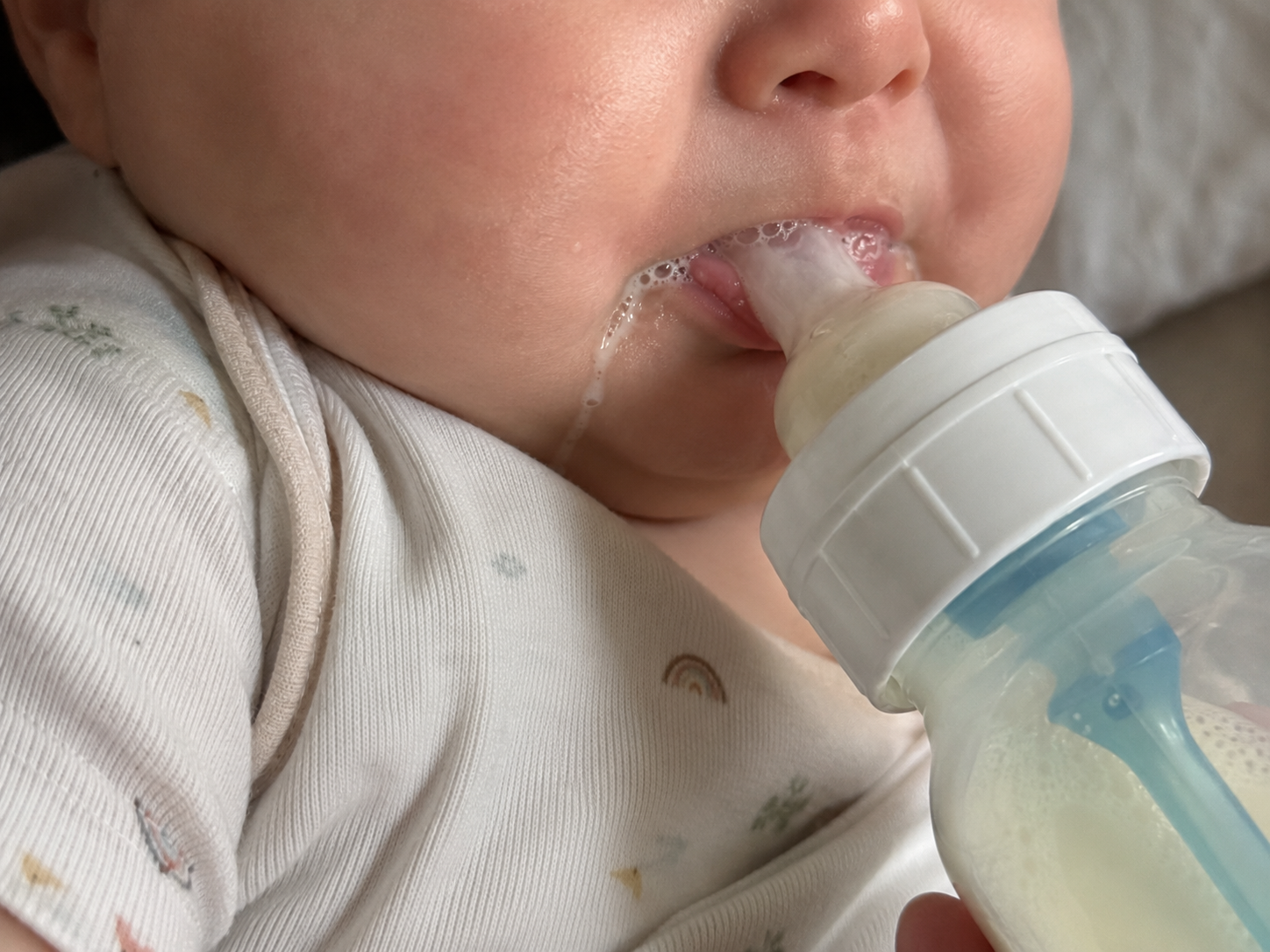 Baby losing milk and foam at the mouth during bottle feeding